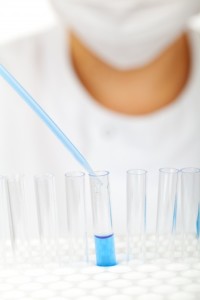 scientist-fills-test-tubes